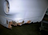 Right rear corner rusted away
